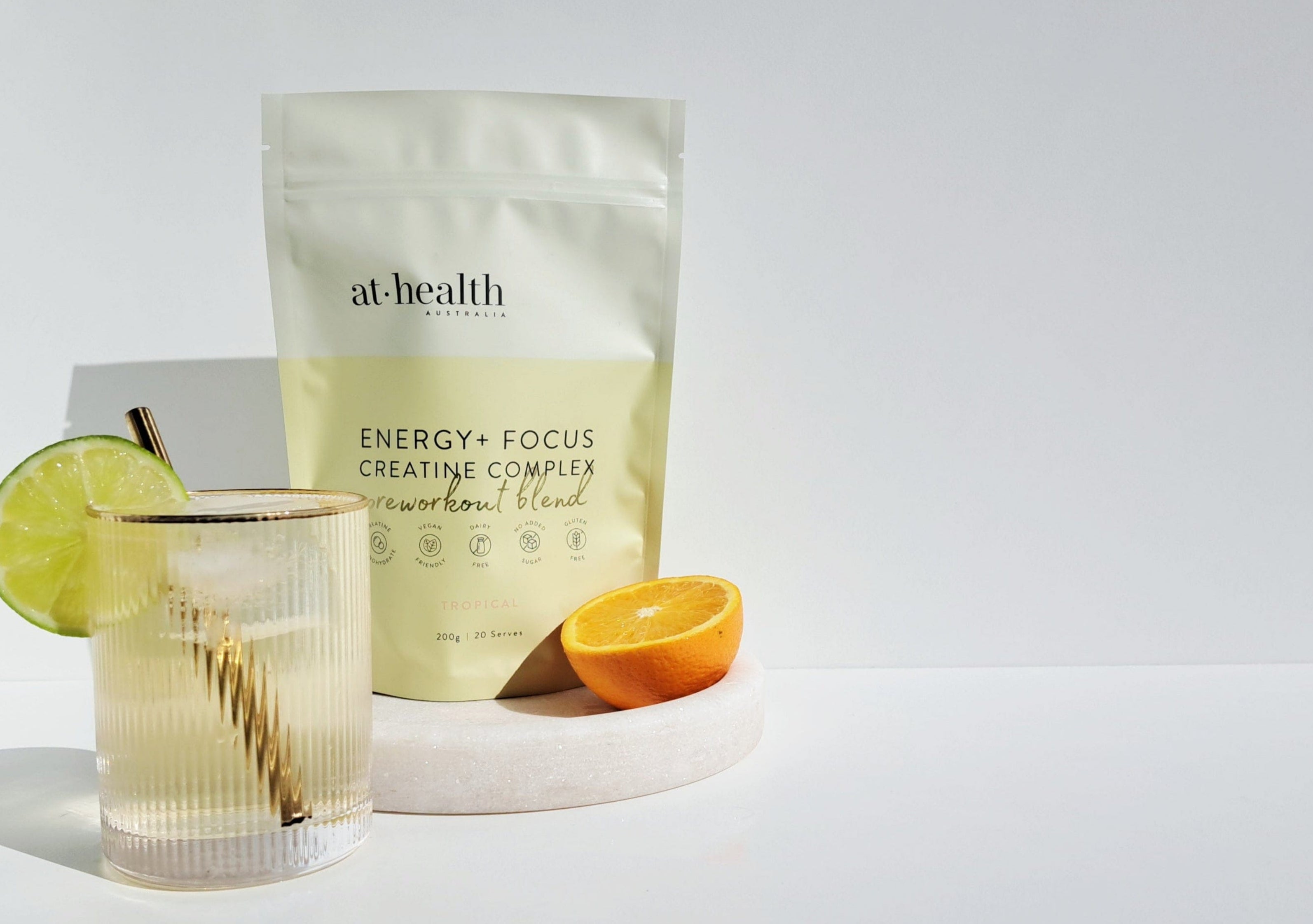 At-Health energy focus creative blend package with a glass of lemonade on a white background